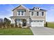 Two-story home with a neutral color scheme, two-car garage, and landscaping at 23 Eagle Crest Ct # Holly English Country, Lillington, NC 27546