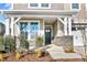 Inviting front porch with stone pillars and a dark green door at 23 Eagle Crest Ct # Holly English Country, Lillington, NC 27546