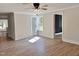 Bright living room with wood floors and ceiling fan at 1011 Lemon Dr, Durham, NC 27705