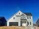 Two-story house with gray siding, white trim, and a two-car garage at 2702 Lacy Holt Rd, Graham, NC 27253