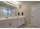 Bathroom boasts a double vanity, mirror, and neutral color palette at 1915 Frost Dr, Haw River, NC 27258