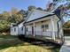 White farmhouse-style home with red door and porch at 2710 - A Mansfield Ave, Durham, NC 27703