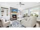 Cozy Gathering room with fireplace, built-in shelves, and large windows at 117 Hardy Oaks Way, Holly Springs, NC 27540