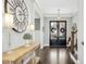 Elegant entryway with hardwood floors, large clock, and double doors at 117 Hardy Oaks Way, Holly Springs, NC 27540