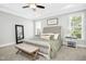 Bright main bedroom with a king-size bed and large windows at 117 Hardy Oaks Way, Holly Springs, NC 27540