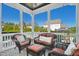 Relaxing screened porch with wicker furniture and tranquil backyard view at 117 Hardy Oaks Way, Holly Springs, NC 27540