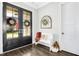 Bright and airy foyer with hardwood floors, decorative wreaths, and a charming bench at 117 Hardy Oaks Way, Holly Springs, NC 27540