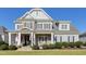 Two-story house with gray siding, stone accents, and a front porch at 117 Hardy Oaks Way, Holly Springs, NC 27540