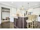 Bright kitchen boasts an island with seating and white cabinetry at 117 Hardy Oaks Way, Holly Springs, NC 27540