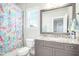 Bathroom with granite countertop vanity and colorful shower curtain at 117 Hardy Oaks Way, Holly Springs, NC 27540