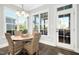 Charming breakfast nook with a round table and wicker chairs, near back door at 117 Hardy Oaks Way, Holly Springs, NC 27540