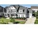 Two-story home with stone accents, welcoming porch, and landscaped yard at 117 Hardy Oaks Way, Holly Springs, NC 27540