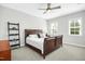 Comfortable bedroom with a wooden bed frame and plenty of natural light at 117 Hardy Oaks Way, Holly Springs, NC 27540