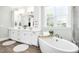 Elegant bathroom with double vanity, soaking tub, and separate shower at 117 Hardy Oaks Way, Holly Springs, NC 27540