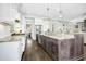 Modern kitchen with granite countertops, stainless steel appliances, and an island at 117 Hardy Oaks Way, Holly Springs, NC 27540