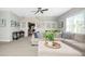 Bright and airy living room with comfortable sectional sofa and large windows at 117 Hardy Oaks Way, Holly Springs, NC 27540