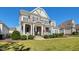 Two-story home with stone accents and rocking chairs at 117 Hardy Oaks Way, Holly Springs, NC 27540