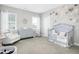 Charming Bedroom with crib, changing table, and plenty of storage at 117 Hardy Oaks Way, Holly Springs, NC 27540