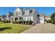 Two-story house with grey siding and large driveway at 117 Hardy Oaks Way, Holly Springs, NC 27540
