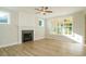 Bright living room features hardwood floors, fireplace, and large windows at 6045 Scalybark Road, Durham, NC 27712
