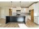 Modern kitchen with large island, white cabinets, and gray countertops at 6045 Scalybark Road, Durham, NC 27712