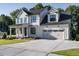 Two story farmhouse style home with a large driveway at 6045 Scalybark Road, Durham, NC 27712