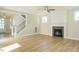 Living room with hardwood floors, fireplace, and ceiling fan at 6045 Scalybark Road, Durham, NC 27712