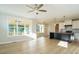 Open concept kitchen with island, white cabinets, and stainless steel appliances at 6045 Scalybark Road, Durham, NC 27712