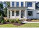 Farmhouse style home with a front porch and landscaping at 6045 Scalybark Road, Durham, NC 27712