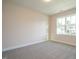 Simple bedroom with neutral walls, carpet flooring and a window at 6045 Scalybark Road, Durham, NC 27712