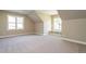 Spacious bonus room with large windows and plush carpeting at 6045 Scalybark Road, Durham, NC 27712