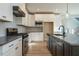 Modern kitchen with stainless steel appliances and white cabinets at 6045 Scalybark Road, Durham, NC 27712