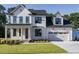 Two story farmhouse style home with a large driveway at 6045 Scalybark Road, Durham, NC 27712