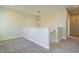 Spacious upper landing with a half wall and carpeted floor at 6045 Scalybark Road, Durham, NC 27712