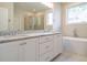 Elegant bathroom with double vanity, granite countertop, and soaking tub at 6045 Scalybark Road, Durham, NC 27712