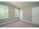 Well-lit bedroom with neutral walls, carpet floor and two windows at 6045 Scalybark Road, Durham, NC 27712