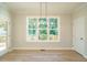 Bright dining area with hardwood floors and large window overlooking deck at 6045 Scalybark Road, Durham, NC 27712