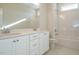 Clean bathroom with double vanity, white cabinets, and bathtub at 6045 Scalybark Road, Durham, NC 27712