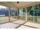 Relaxing screened porch with wooden deck and wooded views at 6045 Scalybark Road, Durham, NC 27712