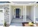 Front entrance with stone accents and a dark blue front door at 108 Northwood Dr, Fuquay Varina, NC 27526