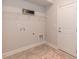 Laundry room with shelving, washer and dryer hookups, and tile floor at 108 Northwood Dr, Fuquay Varina, NC 27526
