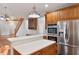 Kitchen with large island, stainless steel appliances, and wood cabinets at 12817 Strickland Rd, Raleigh, NC 27613