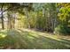 Landscaped yard with trees and grassy areas at 12817 Strickland Rd, Raleigh, NC 27613