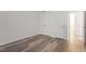 Bright bedroom with wood-look floors and double closets at 7040 Longstreet Dr # C, Raleigh, NC 27615