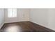 Simple living room with dark hardwood floors and a window at 7040 Longstreet Dr # C, Raleigh, NC 27615