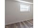 Simple bedroom with wood-look floors and window at 7040 Longstreet Dr # C, Raleigh, NC 27615