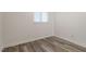 Simple bedroom with wood-look floors and window at 7040 Longstreet Dr # C, Raleigh, NC 27615