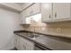 Kitchen with white cabinets, double sink, and tiled backsplash at 7040 Longstreet Dr # C, Raleigh, NC 27615
