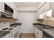 Kitchen with white cabinets and stainless steel appliances at 7040 Longstreet Dr # C, Raleigh, NC 27615