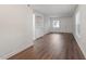 Bright living room featuring hardwood floors and built-in shelving at 7040 Longstreet Dr # C, Raleigh, NC 27615